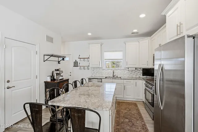 a kitchen with refrigerator and cabinets