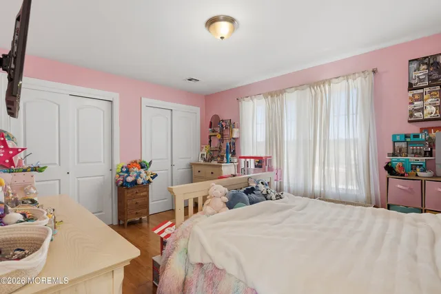 a bedroom with bed and a window