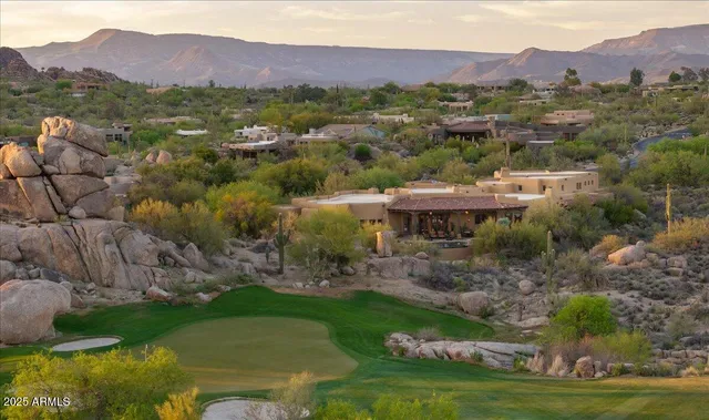 a view of a town with mountains in the background