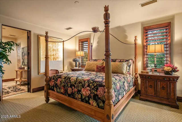 a bed sitting in a bedroom next to a window