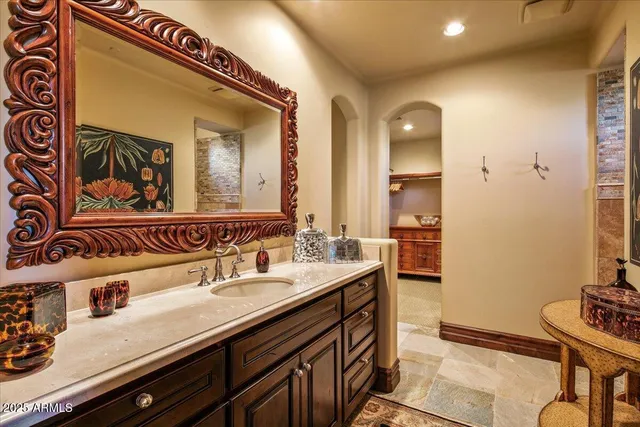 a bathroom with a granite countertop sink and a mirror