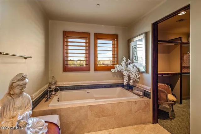 an aerial view of a house with swimming pool and a yard