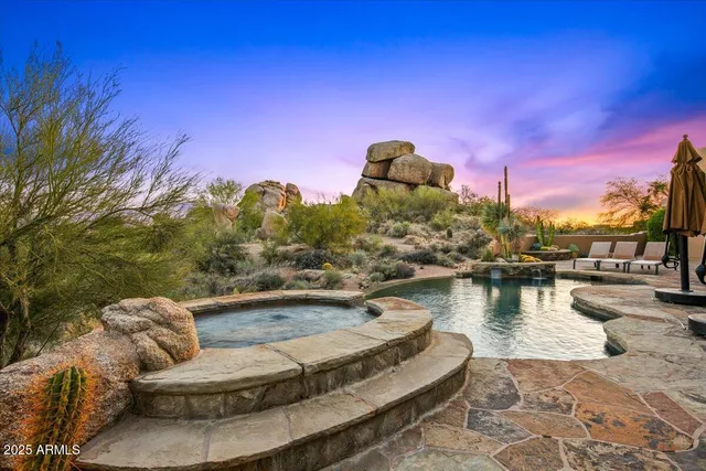 a living room with fireplace furniture and a large window