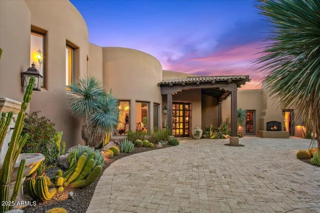 a living room with furniture a chandelier and a large window