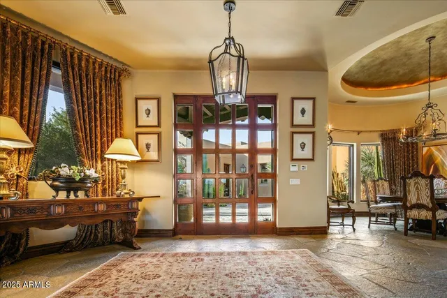 a view of a dining room with furniture and chandelier
