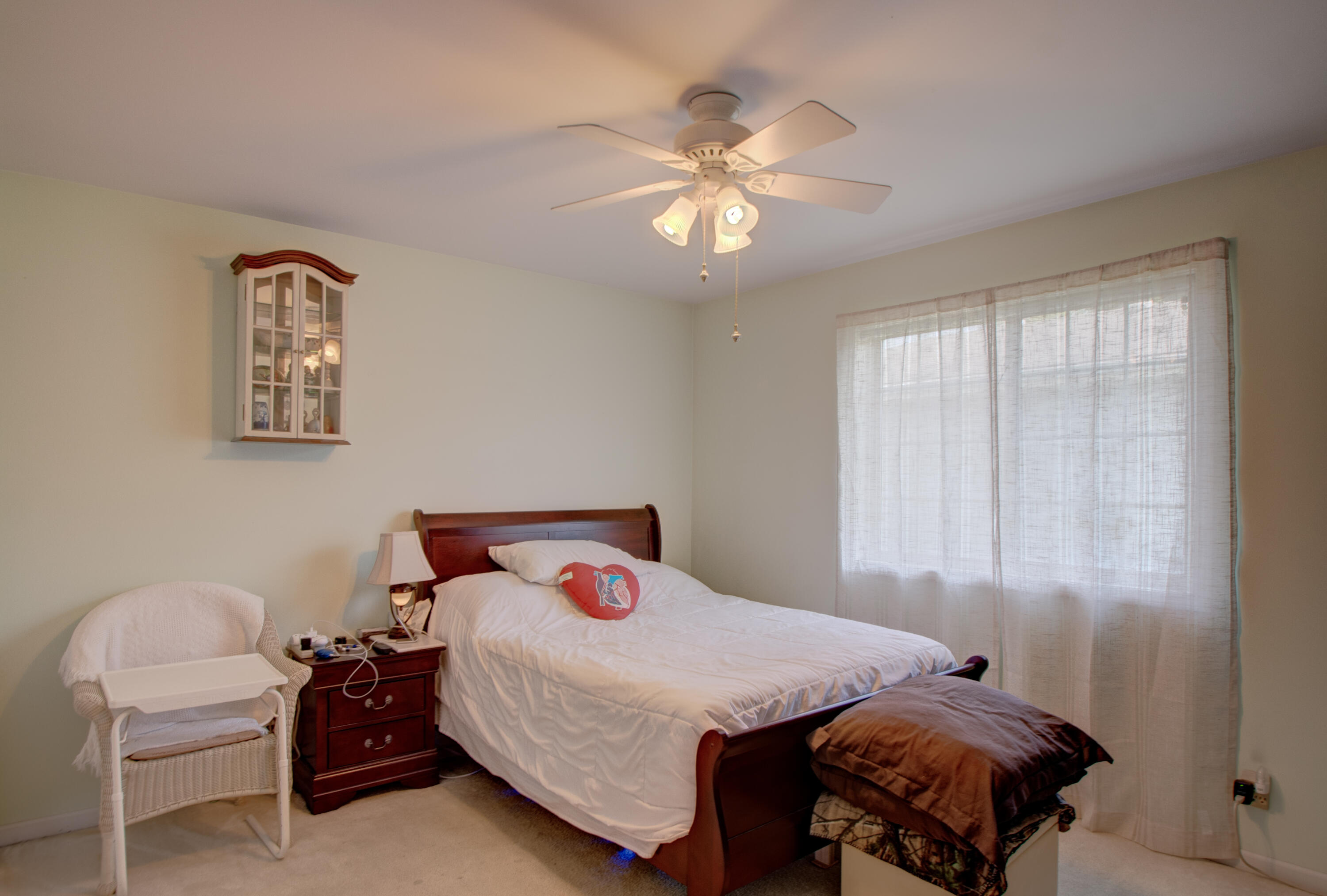337 Pine Ridge Circle Lowell, IN 46356 - Photo 11 of 26 a bedroom with a bed and a chandelier
