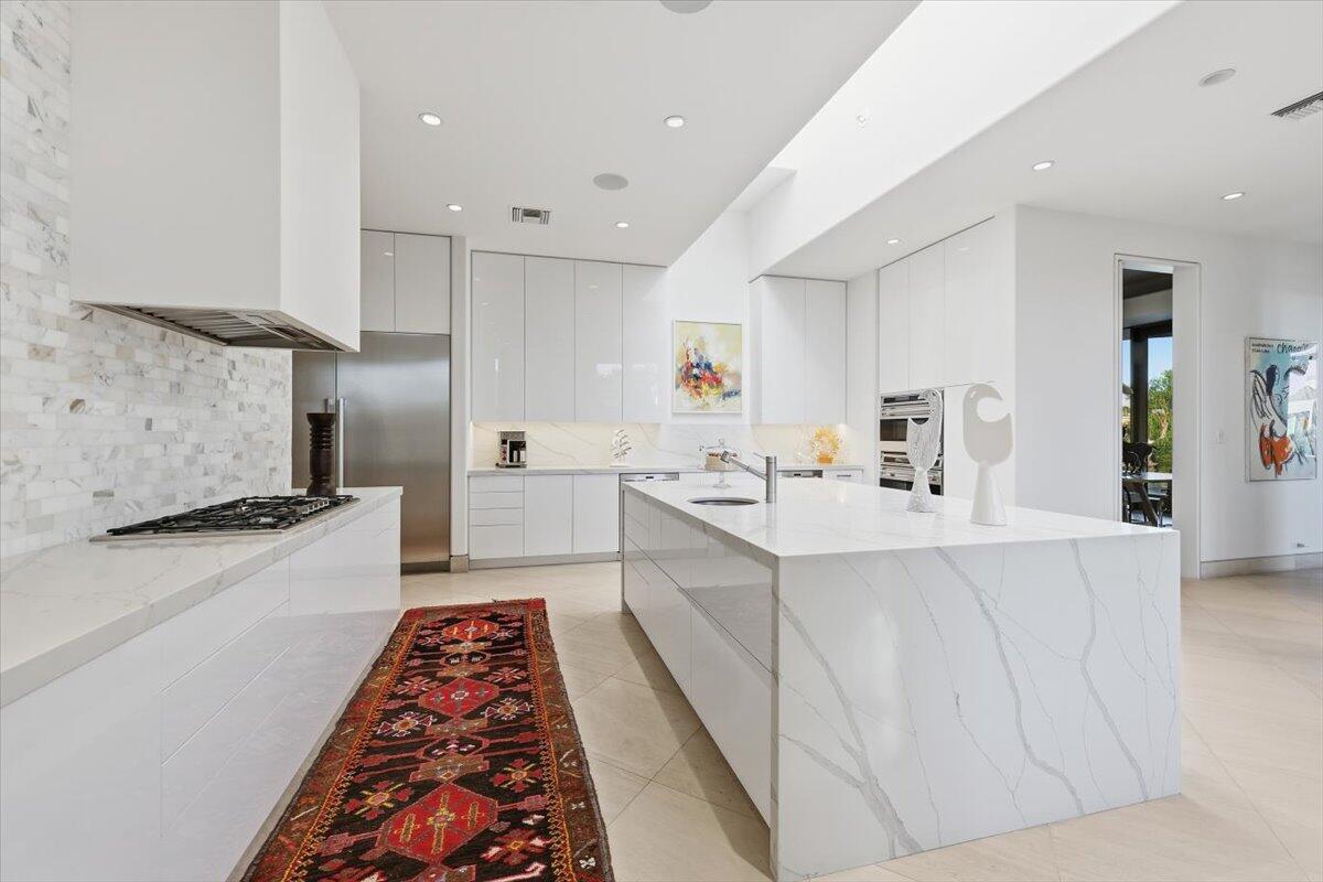 102 Waterford Circle Rancho Mirage, CA 92270 - Photo 16 of 44 a large white kitchen with stainless steel appliances a stove a sink a refrigerator and cabinets
