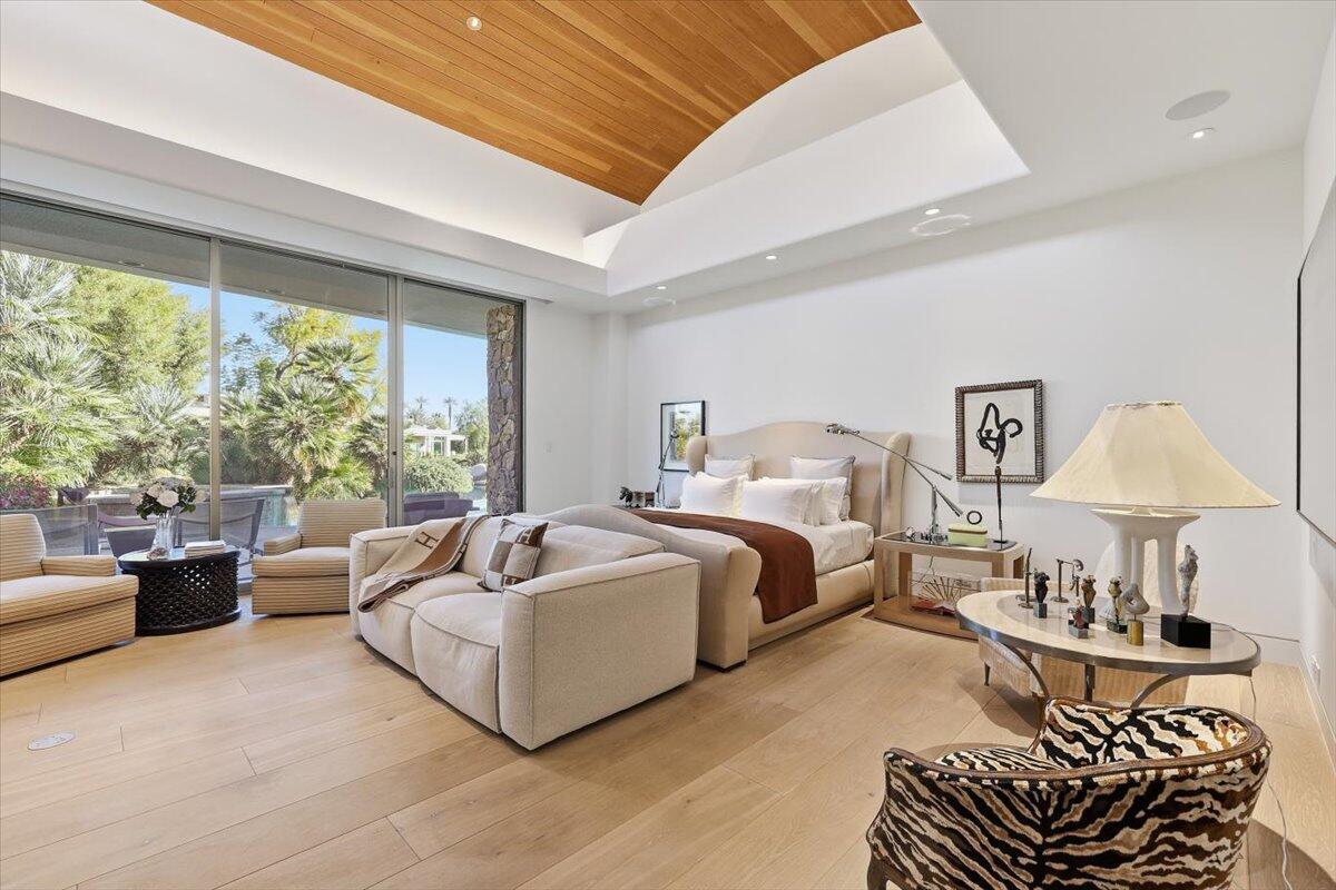 102 Waterford Circle Rancho Mirage, CA 92270 - Photo 20 of 44 a spacious bedroom with a bed and a couch