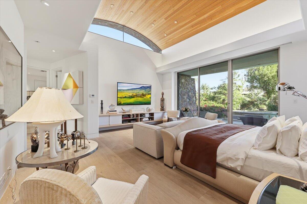 102 Waterford Circle Rancho Mirage, CA 92270 - Photo 21 of 44 a bedroom with a bed and a table