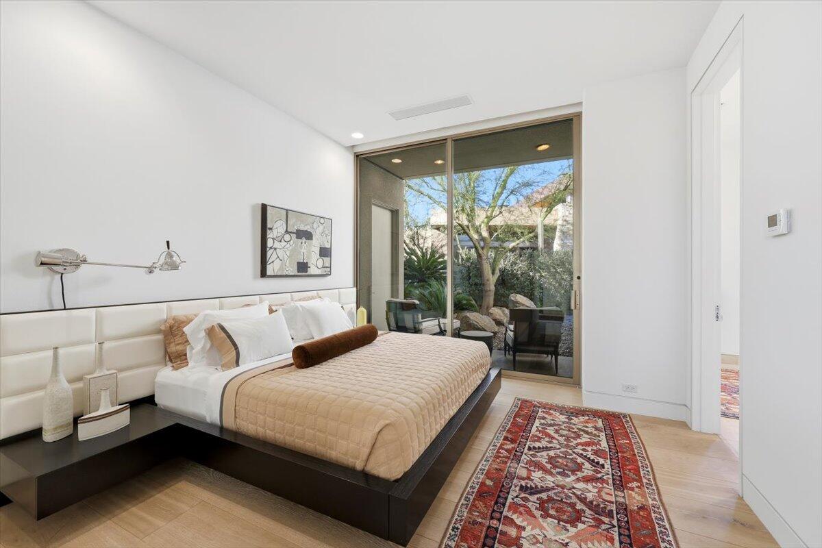 102 Waterford Circle Rancho Mirage, CA 92270 - Photo 28 of 44 a bedroom with a large bed and a rug