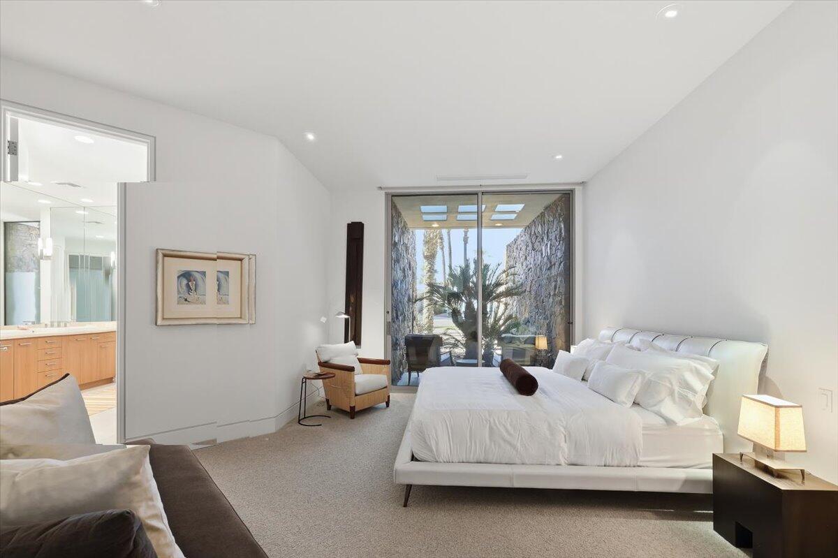 102 Waterford Circle Rancho Mirage, CA 92270 - Photo 30 of 44 a bedroom with a bed lamp and window