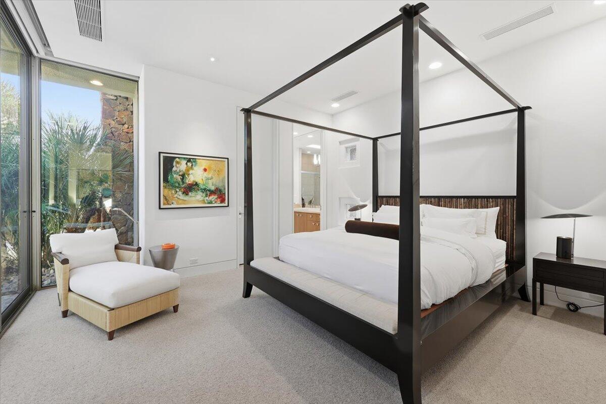 102 Waterford Circle Rancho Mirage, CA 92270 - Photo 34 of 44 a bedroom with a bed lamp and window