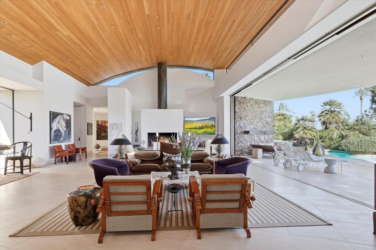 102 Waterford Circle Rancho Mirage, CA 92270 - Photo 7 of 44 a living room with fireplace furniture and a large window
