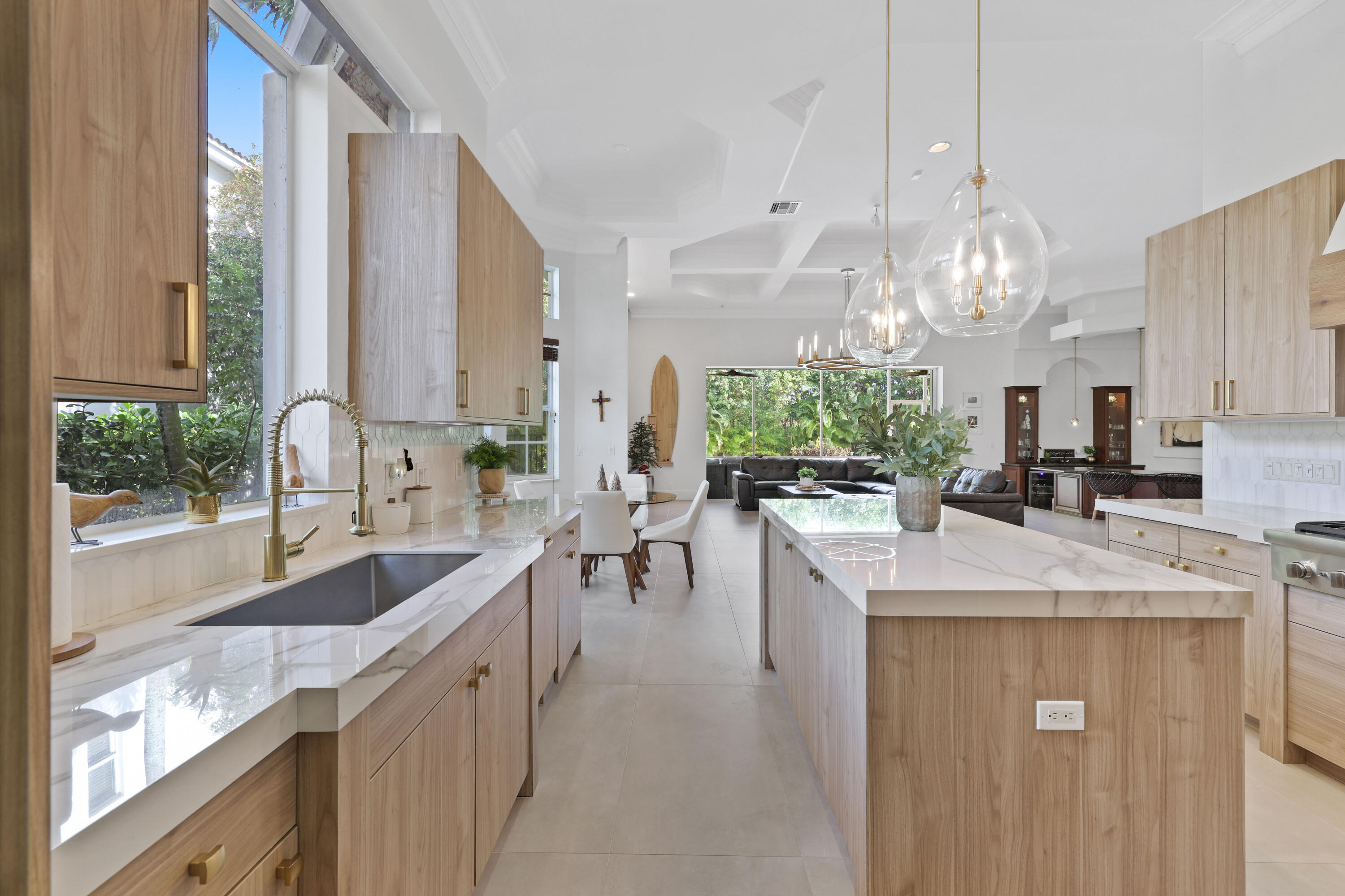 562 Rookery Place Jupiter, FL 33458 - Photo 21 of 72 a kitchen with kitchen island granite countertop a sink a counter top space and living room view