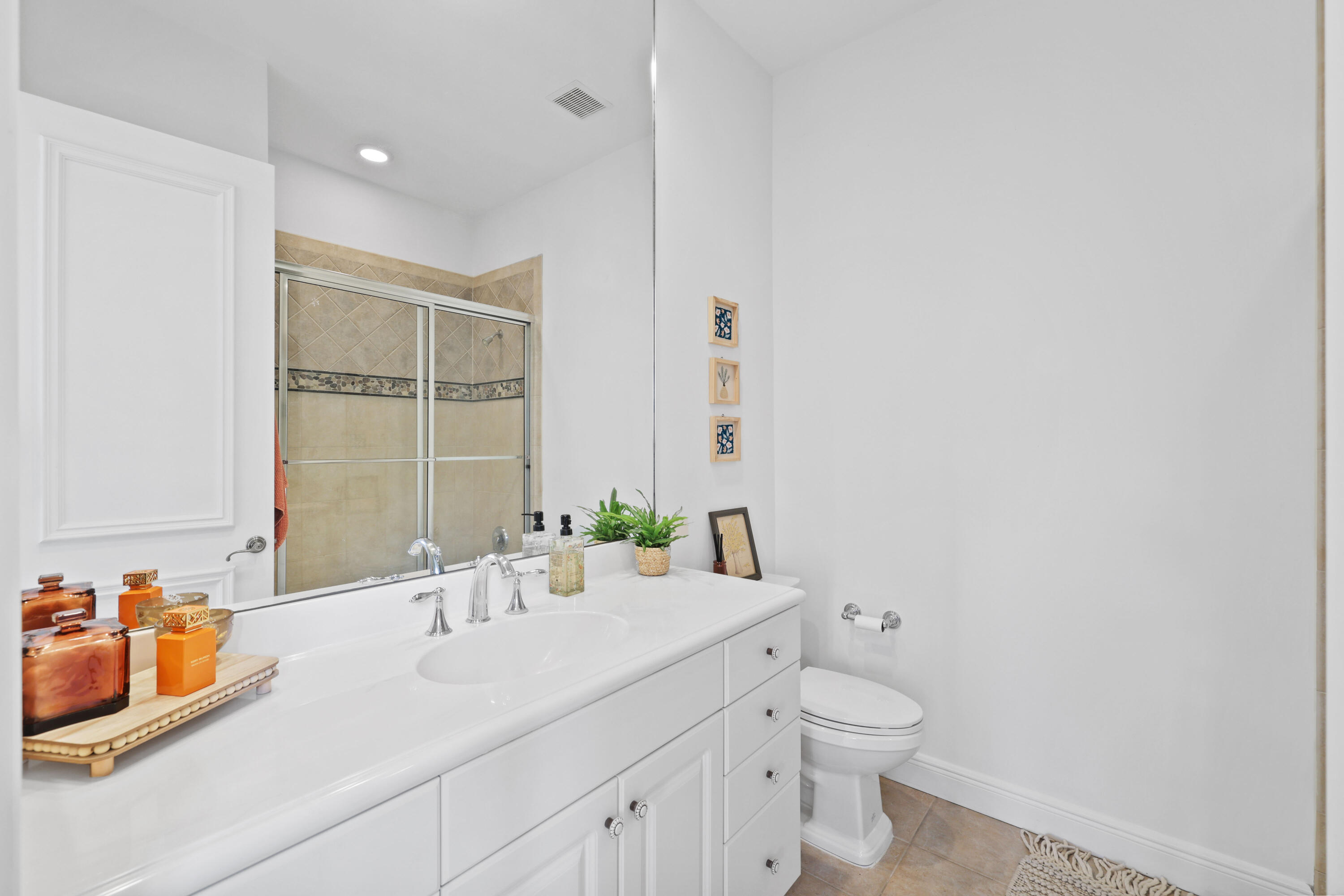 562 Rookery Place Jupiter, FL 33458 - Photo 46 of 72 a bathroom with a toilet sink and mirror
