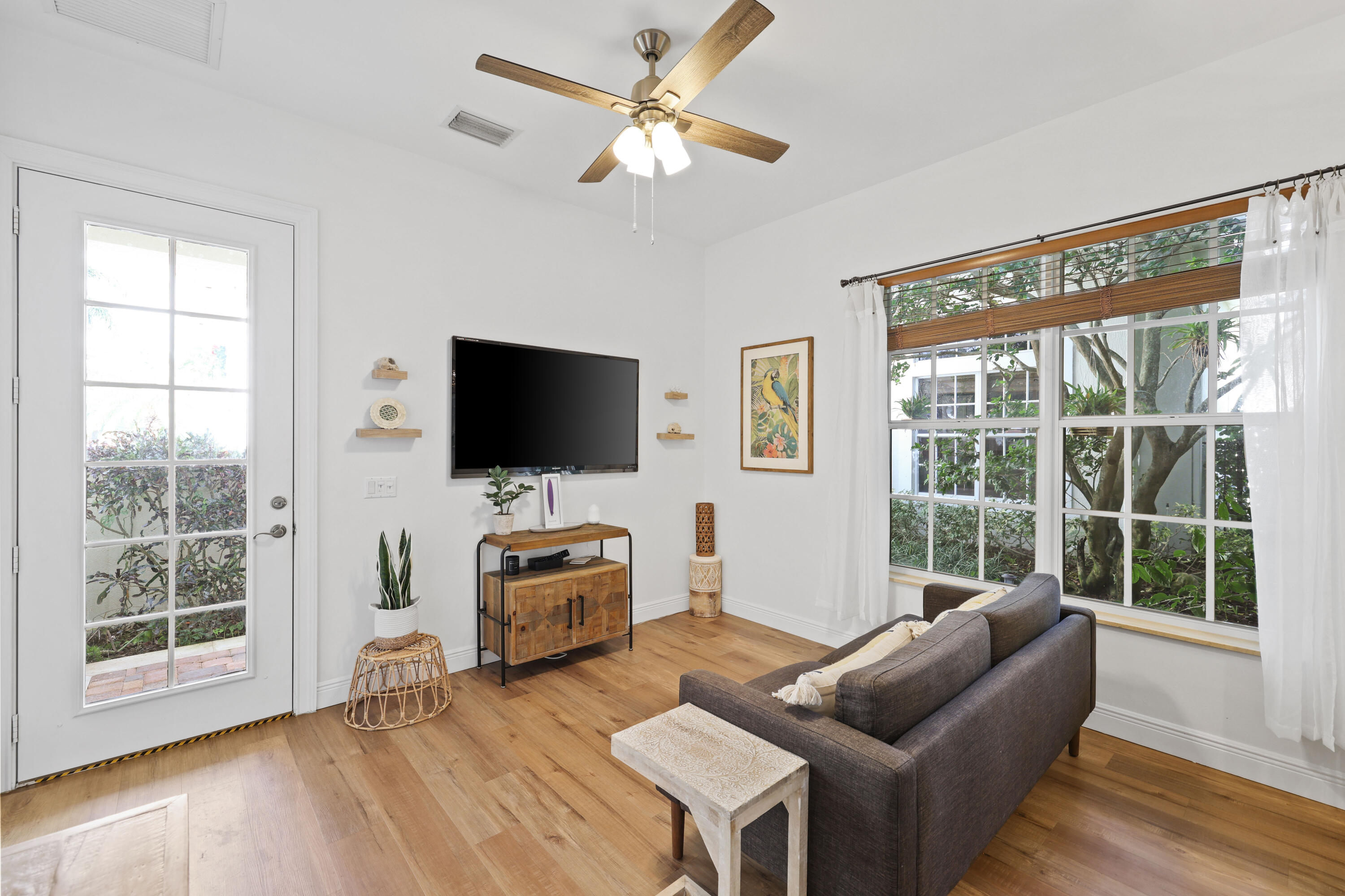562 Rookery Place Jupiter, FL 33458 - Photo 58 of 72 a living room with furniture a flat screen tv and a large window