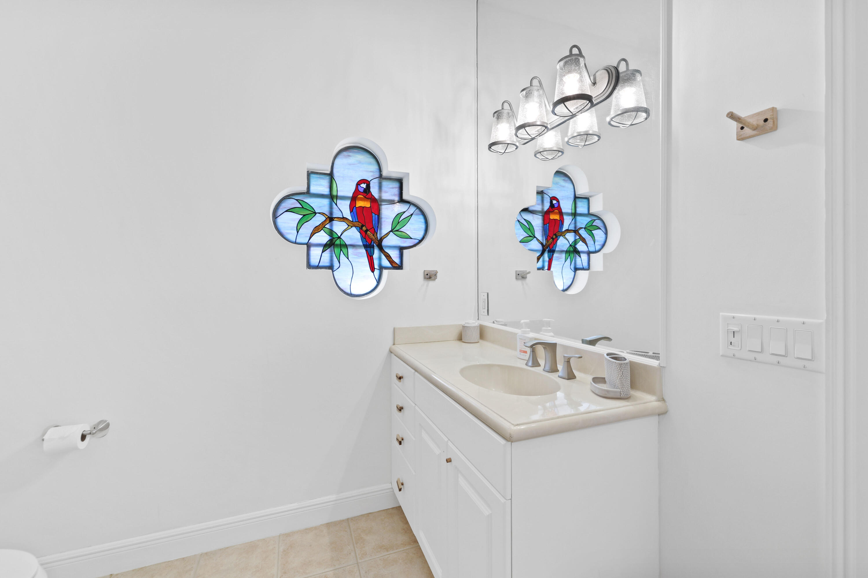 562 Rookery Place Jupiter, FL 33458 - Photo 63 of 72 a bathroom with a sink and mirror