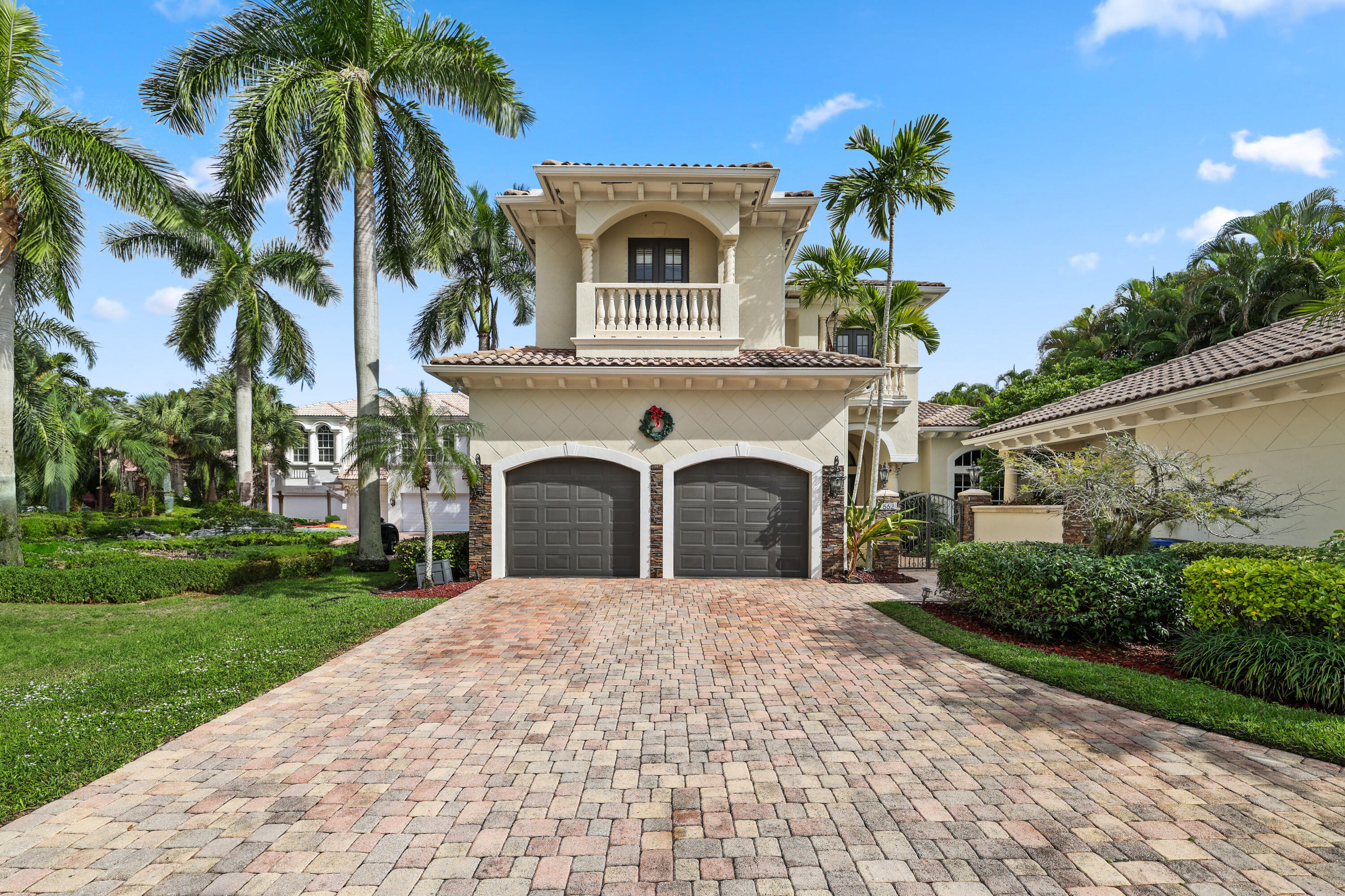 562 Rookery Place Jupiter, FL 33458 - Photo 70 of 72 a front view of a house with a garden and trees