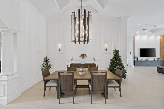 a living room with furniture kitchen and a chandelier