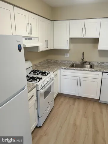 a kitchen with stainless steel appliances granite countertop a stove and a sink