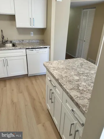 a kitchen with granite countertop white cabinets and a granite counter tops