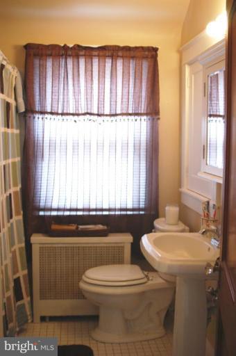 5546 Ashbourne Road Halethorpe, MD 21227 - Photo 12 of 26 a bathroom with a toilet a sink and a window