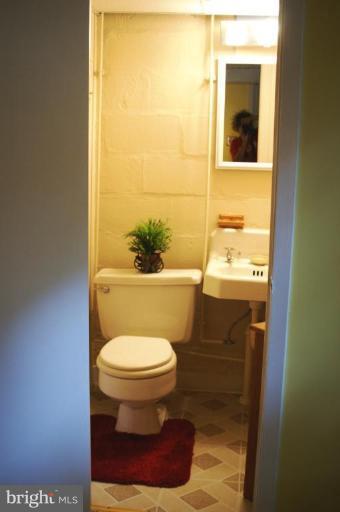 5546 Ashbourne Road Halethorpe, MD 21227 - Photo 19 of 26 a bathroom with a toilet and a sink