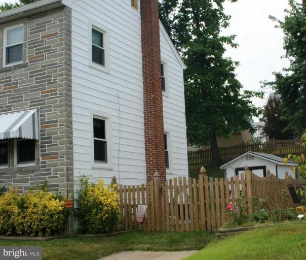 5546 Ashbourne Road Halethorpe, MD 21227 - Photo 25 of 26 a view of a house with a yard and a large tree