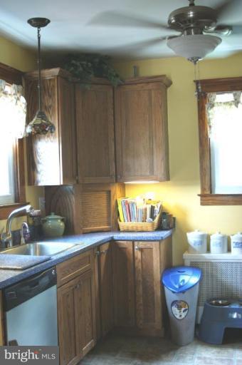 5546 Ashbourne Road Halethorpe, MD 21227 - Photo 6 of 26 a kitchen with a sink a stove cabinets and dining table