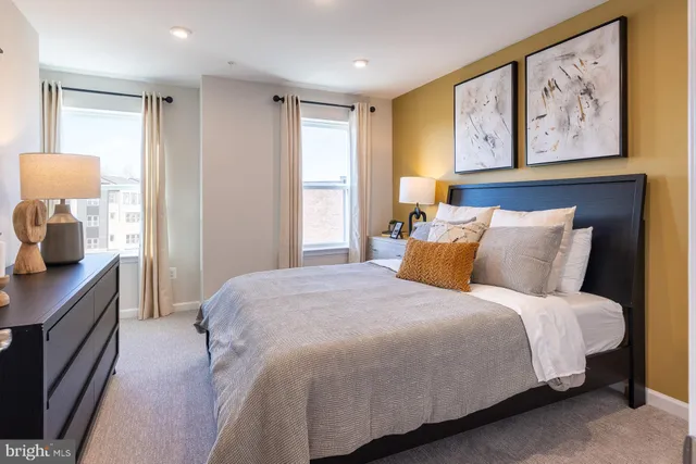 a bedroom with bed and painting on the wall