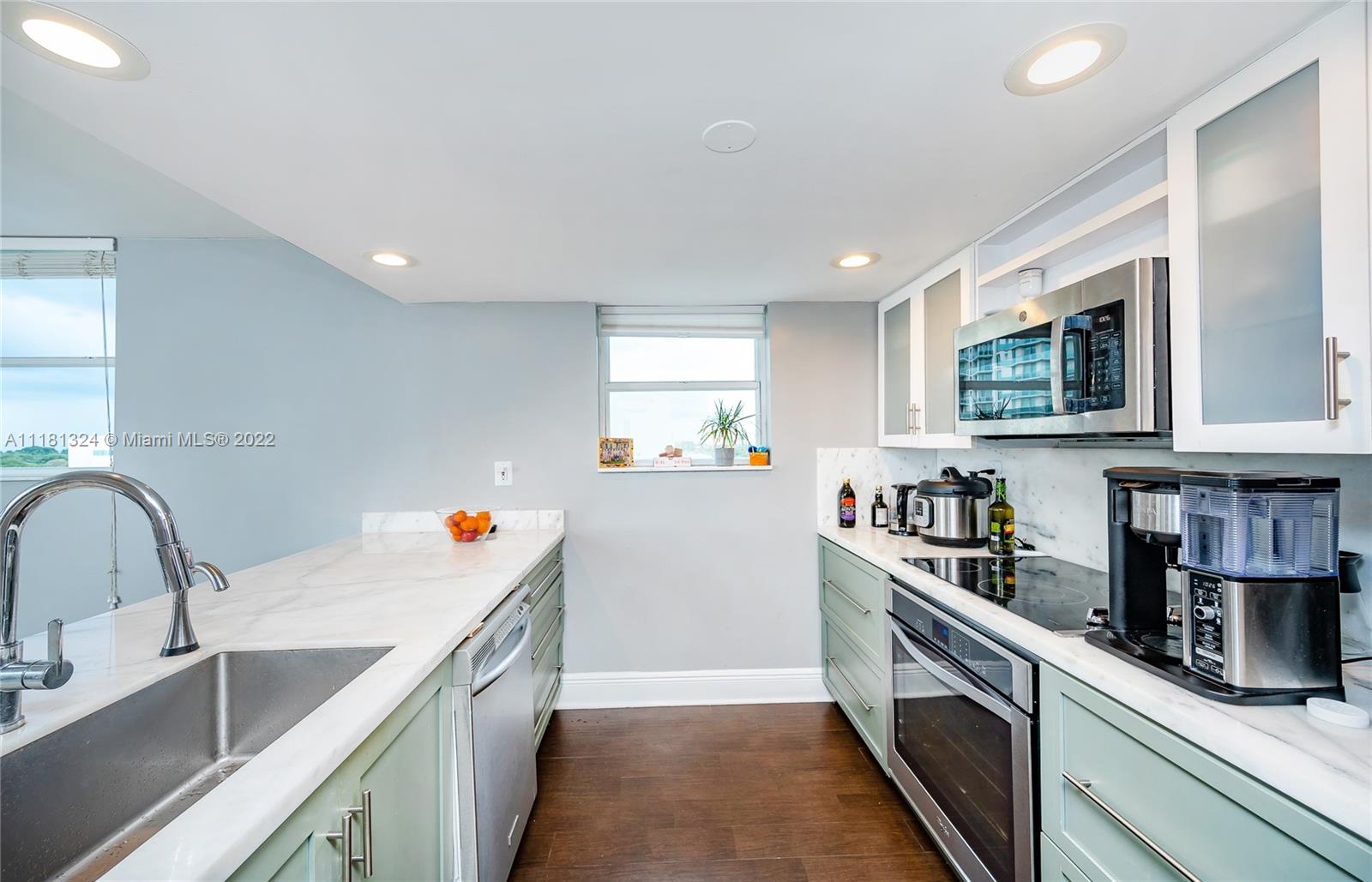2400 Southwest 3rd Avenue, Unit 802 Miami, FL 33129 - Photo 15 of 26 a kitchen that has a sink and a stove in it