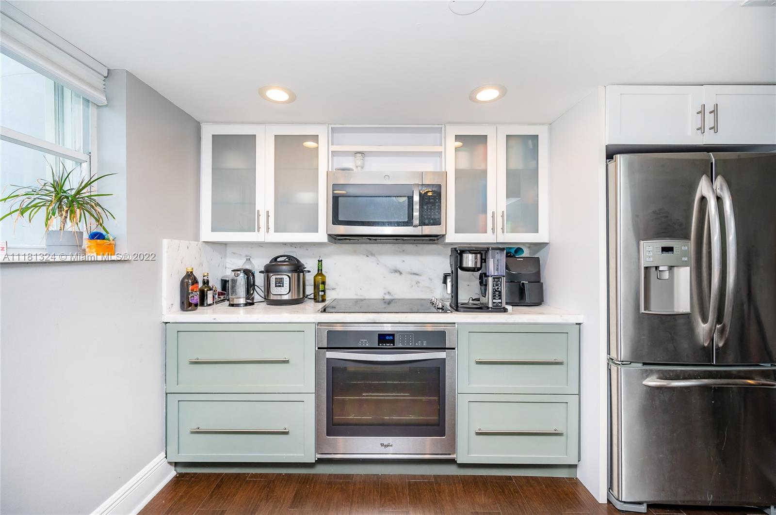 2400 Southwest 3rd Avenue, Unit 802 Miami, FL 33129 - Photo 16 of 26 a kitchen with stainless steel appliances a stove a refrigerator and a sink