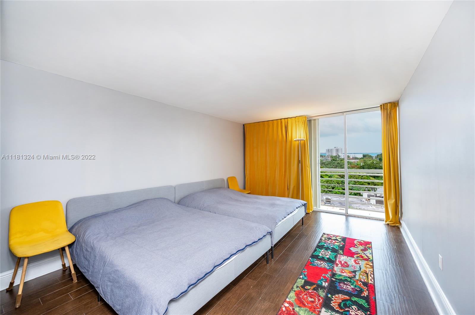 2400 Southwest 3rd Avenue, Unit 802 Miami, FL 33129 - Photo 18 of 26 a bedroom with a bed a painting on the wall and a baby crib