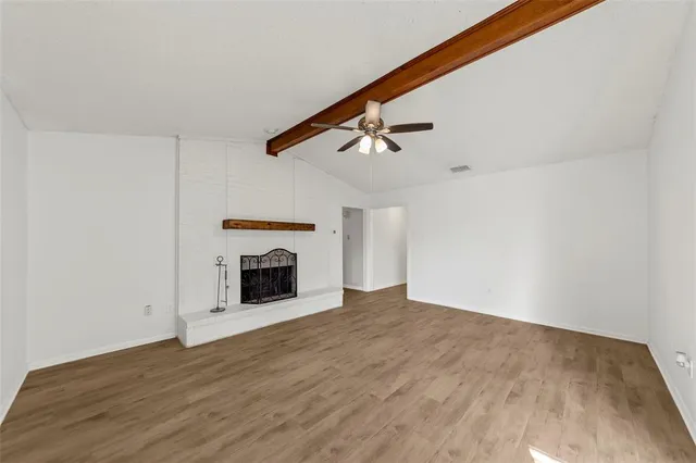 a view of empty room with fireplace