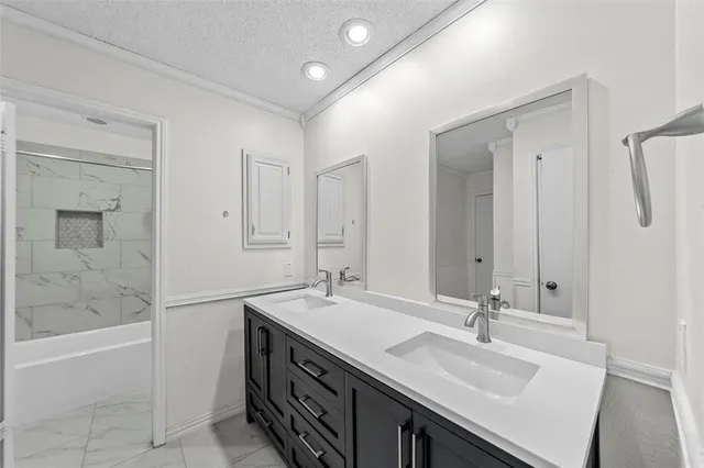 a bathroom with a double vanity sink a mirror and a bathtub