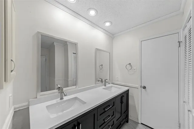 a bathroom with a sink double vanity and a mirror