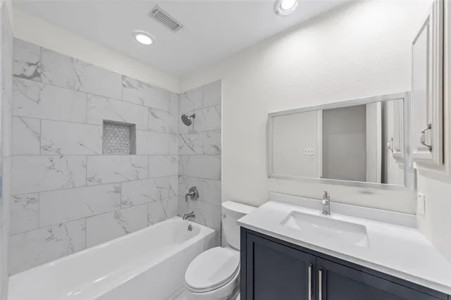 a bathroom with a sink a toilet and bathtub