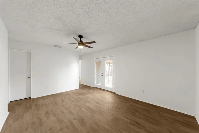 a view of an empty room with wooden floor