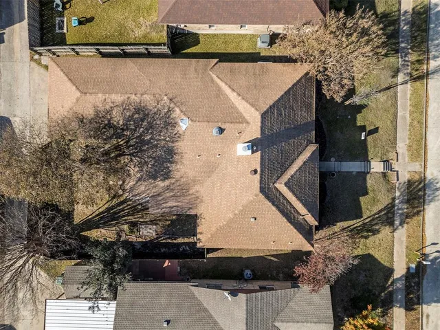 an aerial view of a house with a yard