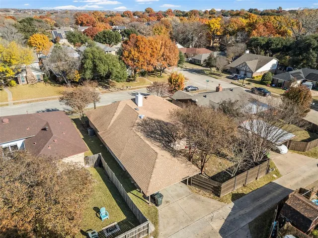 an aerial view of residential houses with outdoor space