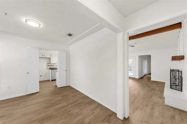 a view of a big room with wooden floor and a bathroom
