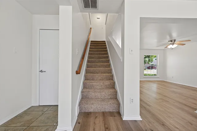 a view of entryway and hall with wooden floor