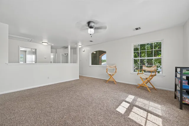 a view of a livingroom with furniture and windows