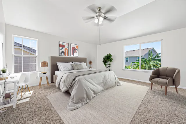 a spacious bedroom with a large bed and a chair