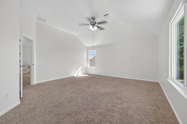 a view of a livingroom with a ceiling fan and window