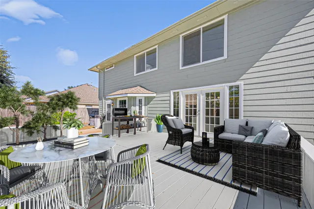 a view of a patio with couches table and chairs and potted plants