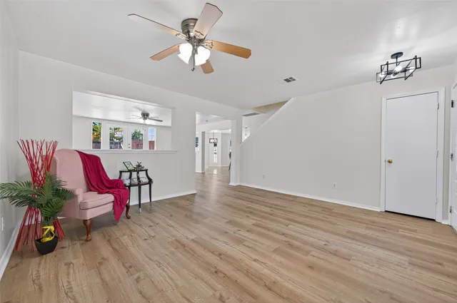 a view of an empty room with wooden floor