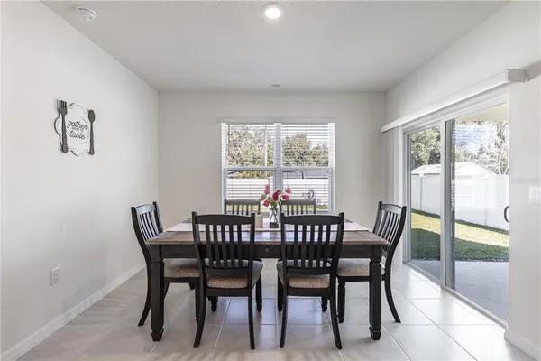 a view of a dining room with furniture a couch and wooden floor