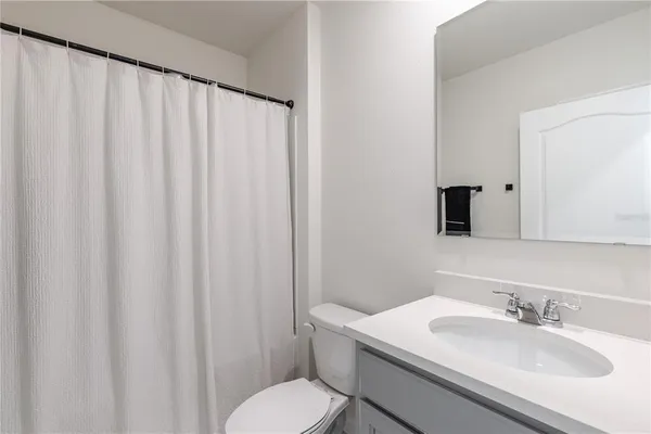 a bathroom with a sink toilet and mirror