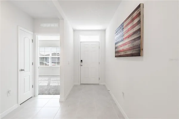 a view of a hallway with closet and bathroom